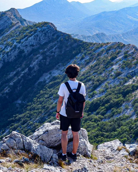 Standing on a mountain ridge
